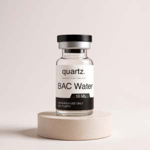 Bacteriostatic Water 10ml research vial on travertine pedestal – Quartz Peptides