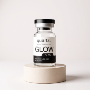 GLOW 70mg research vial on travertine pedestal – Quartz Peptides